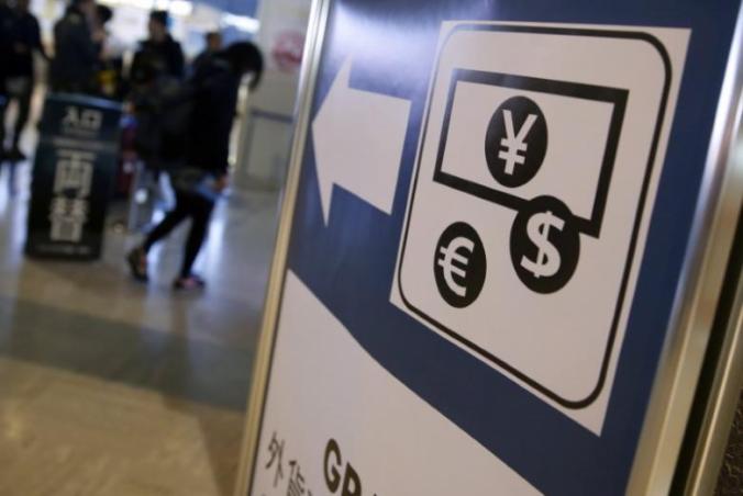 Currency signs of Japanese Yen, Euro and the U.S. dollar are seen on a board outside a currency exchange office at Narita International airport, near Tokyo, Japan, March 25, 2016. REUTERS/Yuya Shino - RTSC6D9
