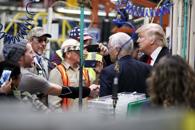  President-elect Donald Trump and Vice President-elect Mike Pence talk with factory workers during a visit to the Carrier factory, Thursday, Dec. 1, 2016, in Indianapolis, Ind. AP Photo/Evan Vucci 